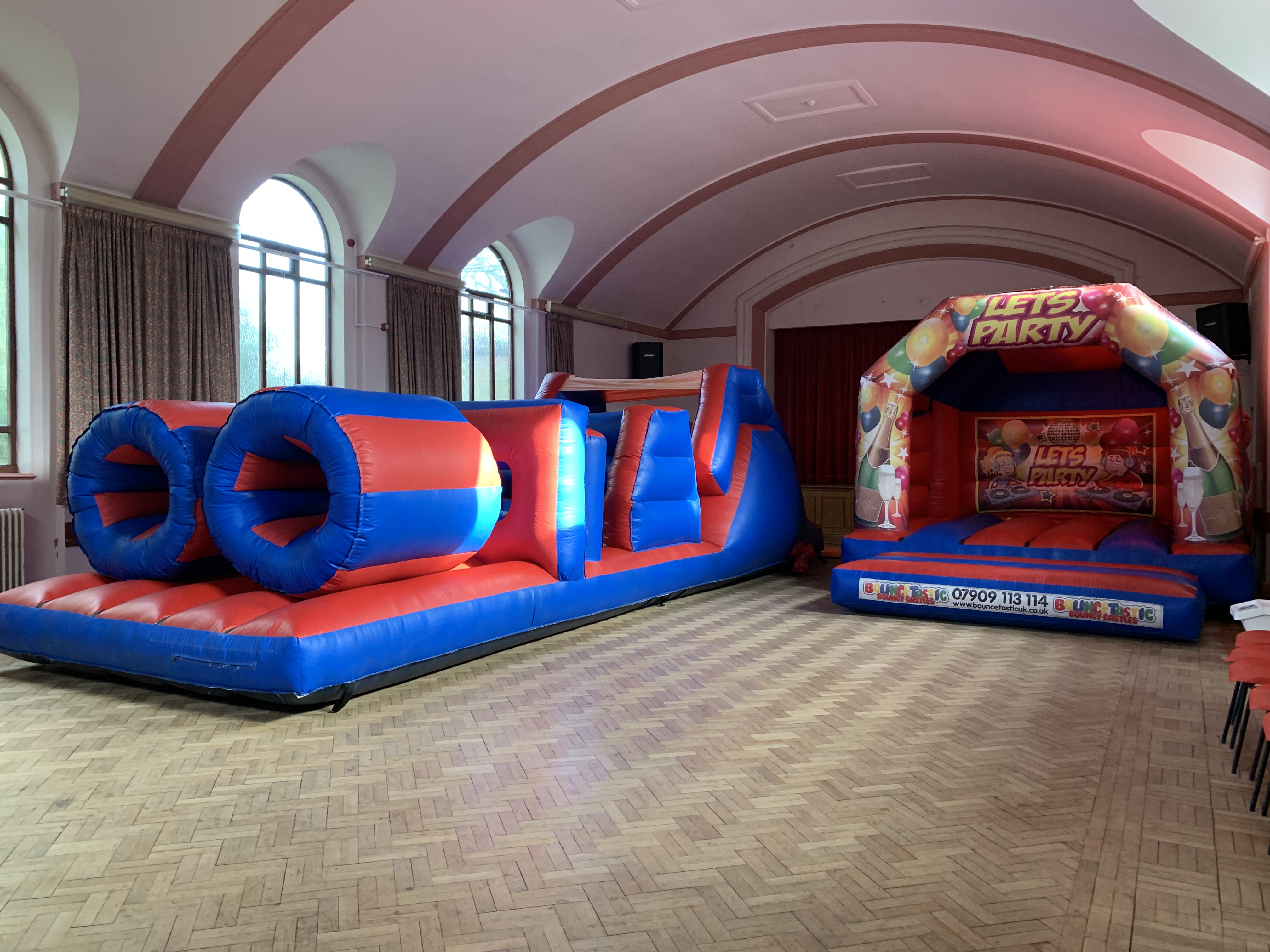 A bouncy castle and assault course on an indoor hire Indoor bouncy castle hire